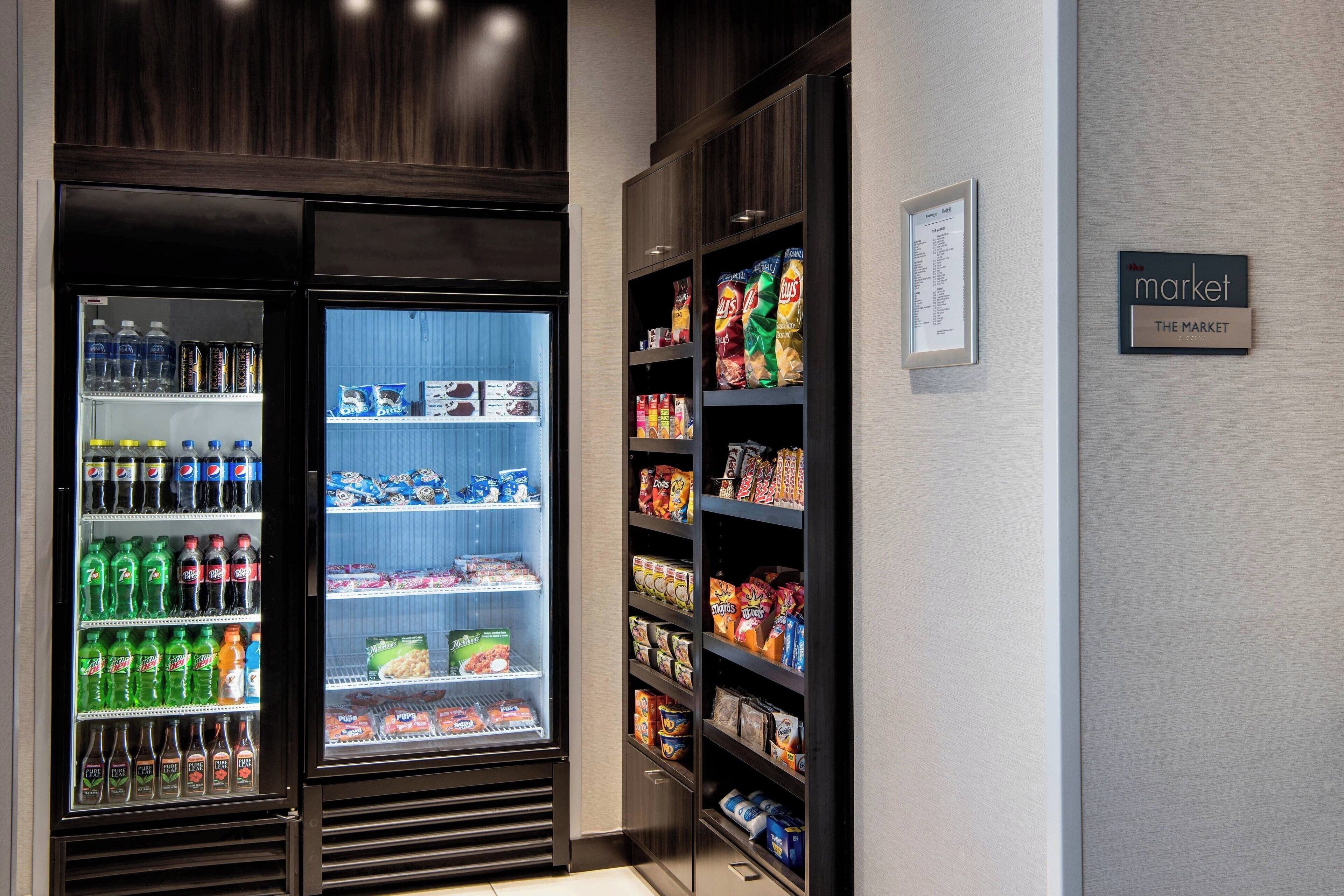 A vending machine area with Pepsi, 7UP, and other sodas, snacks, and packaged foods.