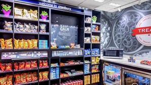 A snack and beverage section with various brands and products, including a chalkboard with 'KEEP CALM AND SUMMER ON' written on it.
