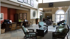 A spacious lobby with wicker furniture, framed artwork on the walls, and a coffee station. - Ocean Key Resort spacious 1 bedroom suite (Virginia Beach)