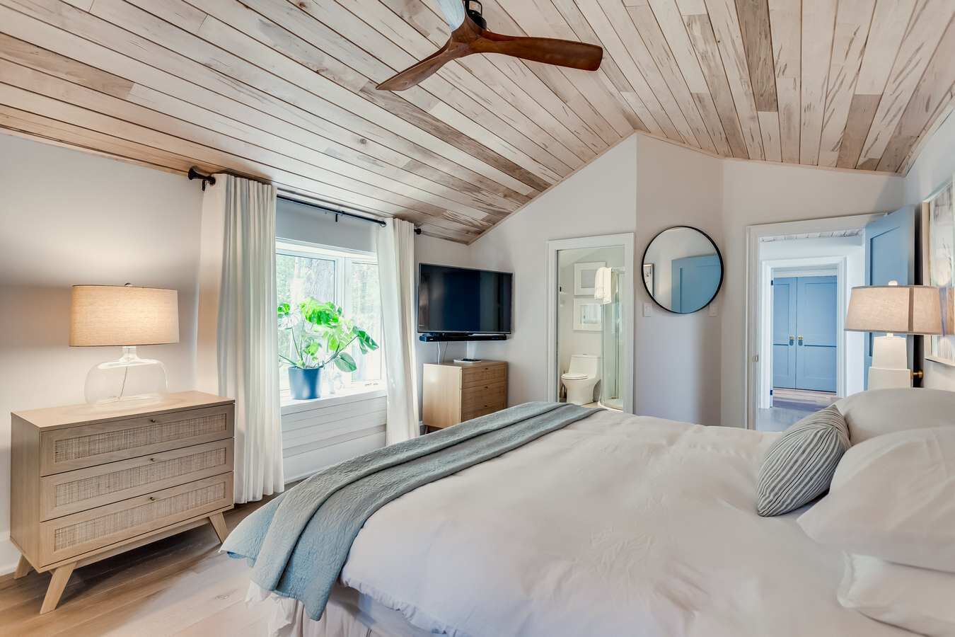 upper level bedroom with semi ensuite, king bed, TV work station not in photo