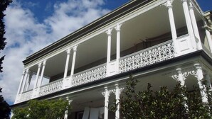 A building with a balcony and columns.