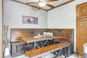 A wooden bench and table in a corner with a ceiling fan above. - Brian Head Condo w/ Pool Access - Steps to Resort! (Brian Head)