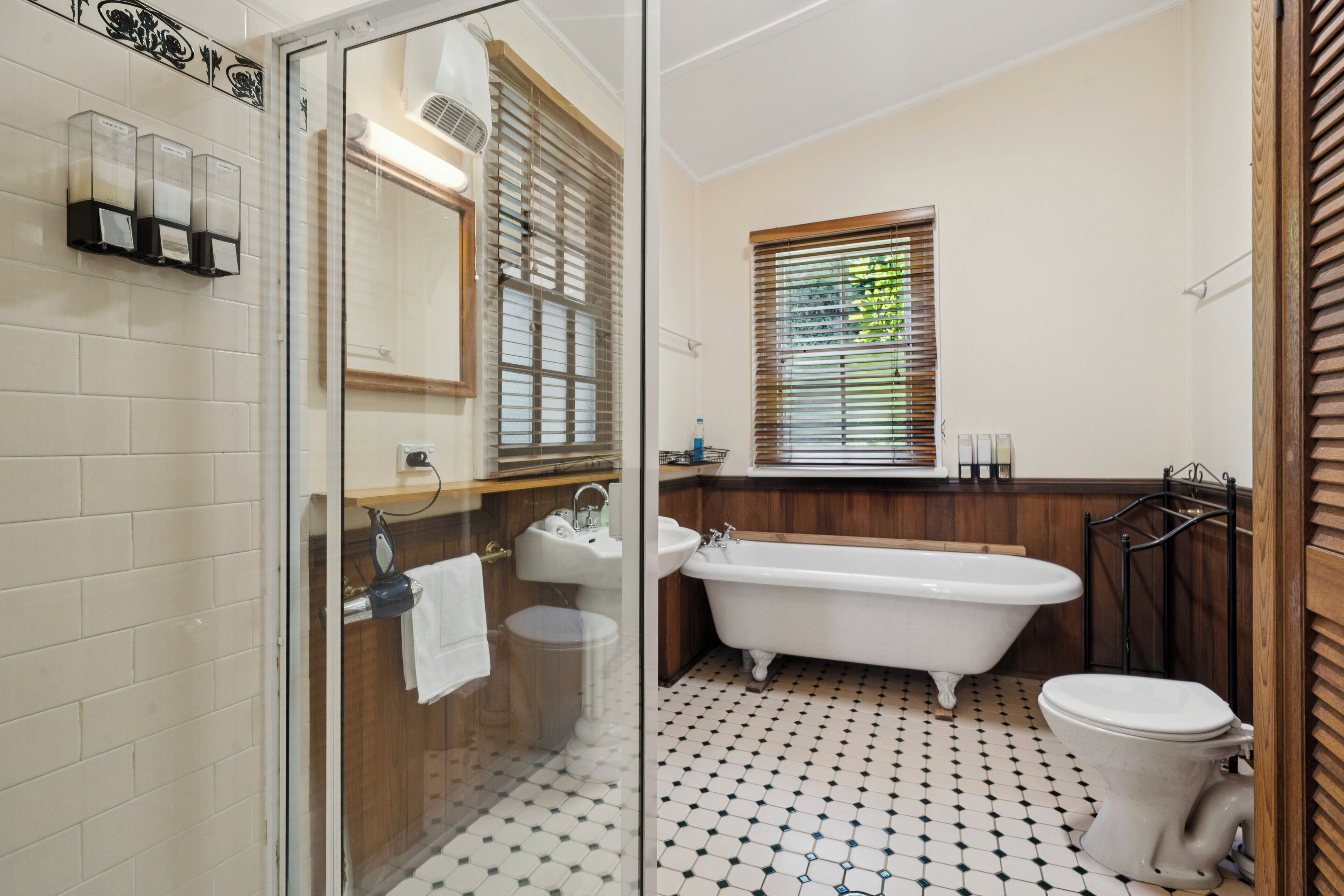 Bathtub, hair dryer, towels, shampoo