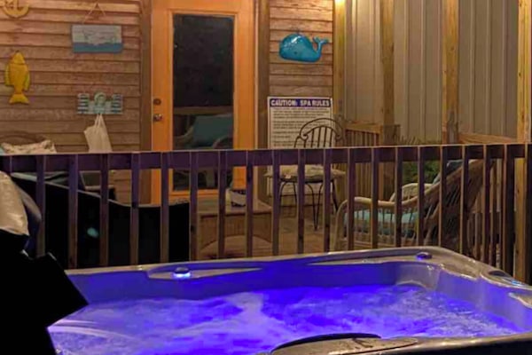 Hot tub by covered deck and gameroom