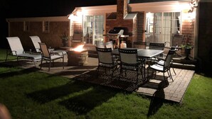 An outdoor patio with a fire pit, seating, and a grill area. - Fun & Sun in Osterville MA - Sleeps 10, Beach Pass (Barnstable)