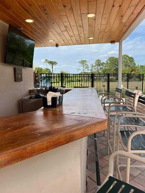 Relax with a drink at this outdoor bar, featuring a flat-screen TV and comfortable seating.