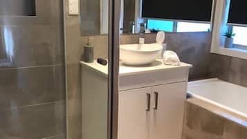 Bathtub, hair dryer, towels, soap
