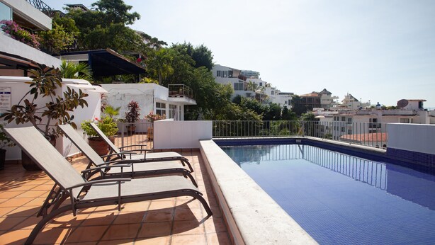 A rooftop pool with lounge chairs, surrounded by terracotta tiles and potted plants. - Rincon Del Almendro 1BD Studio for rent in Old Town, Puerto vallarta (Puerto Vallarta)