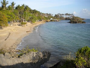 A beach with clear waters, a sandy shore, and a rocky outcrop. - Full, Spacious Duplex Apartment Walking Distance to the Beach!!! (Costambar)
