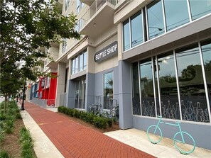 A building with a 'BOTTLE SHOP' sign, large windows, and a bicycle parked outside.