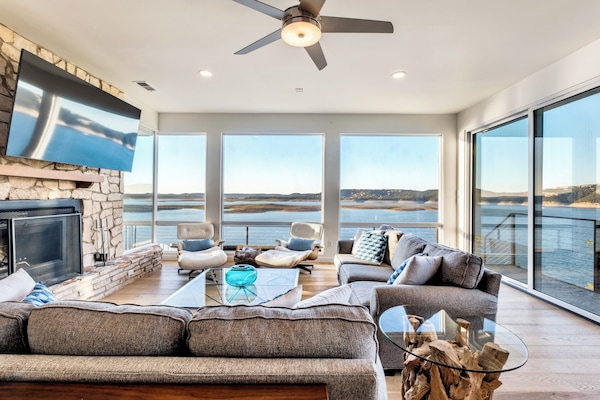 Lakefront living! Massive lake views through the walls of windows.