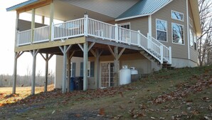 A two-story house with a balcony and a covered porch. - BLOW OUT-SALE PRICES!  3 DAY FOLIAGE,Fishing, Dock, Fire Pit, Boat launch & Boat (North Hero)