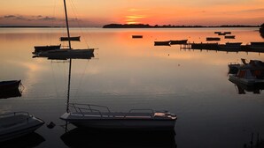 A marina with several boats docked at calm water during sunset. - Stagnone Area Zero (Marsala)