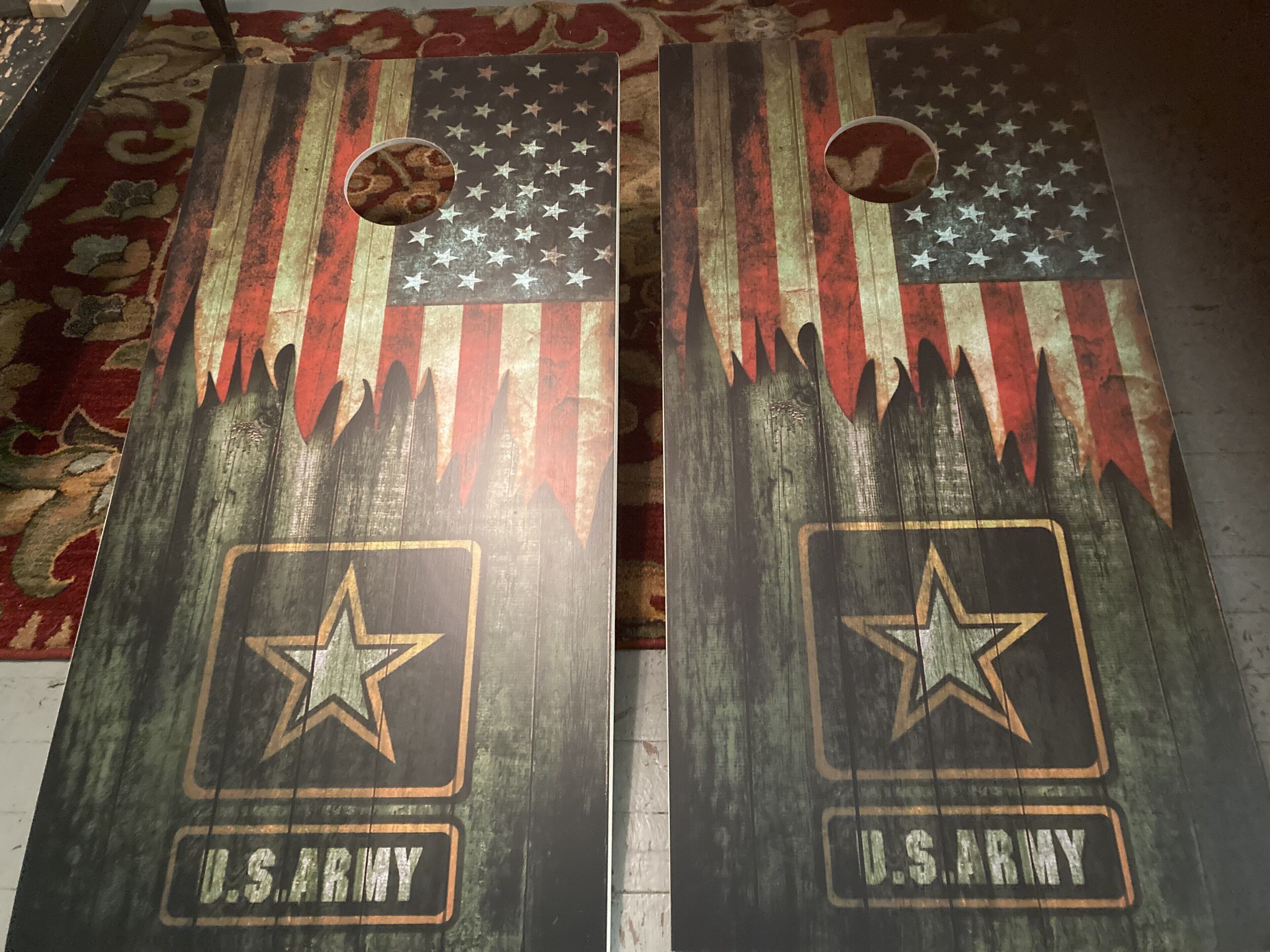 Two wooden plaques with U.S. Army insignia, one with a circular cutout and one with a star cutout, placed on a patterned carpet.