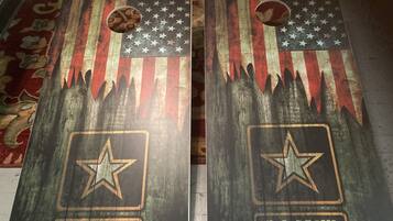 Two wooden plaques with U.S. Army insignia, one with a circular cutout and one with a star cutout, placed on a patterned carpet.