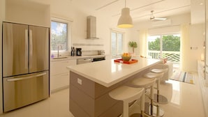 A modern kitchen with a large island, stainless steel appliances, and a bright, airy design. - Bayfront 1BR Apt - Central Location & GREAT Rates! (Governor`s Harbour)