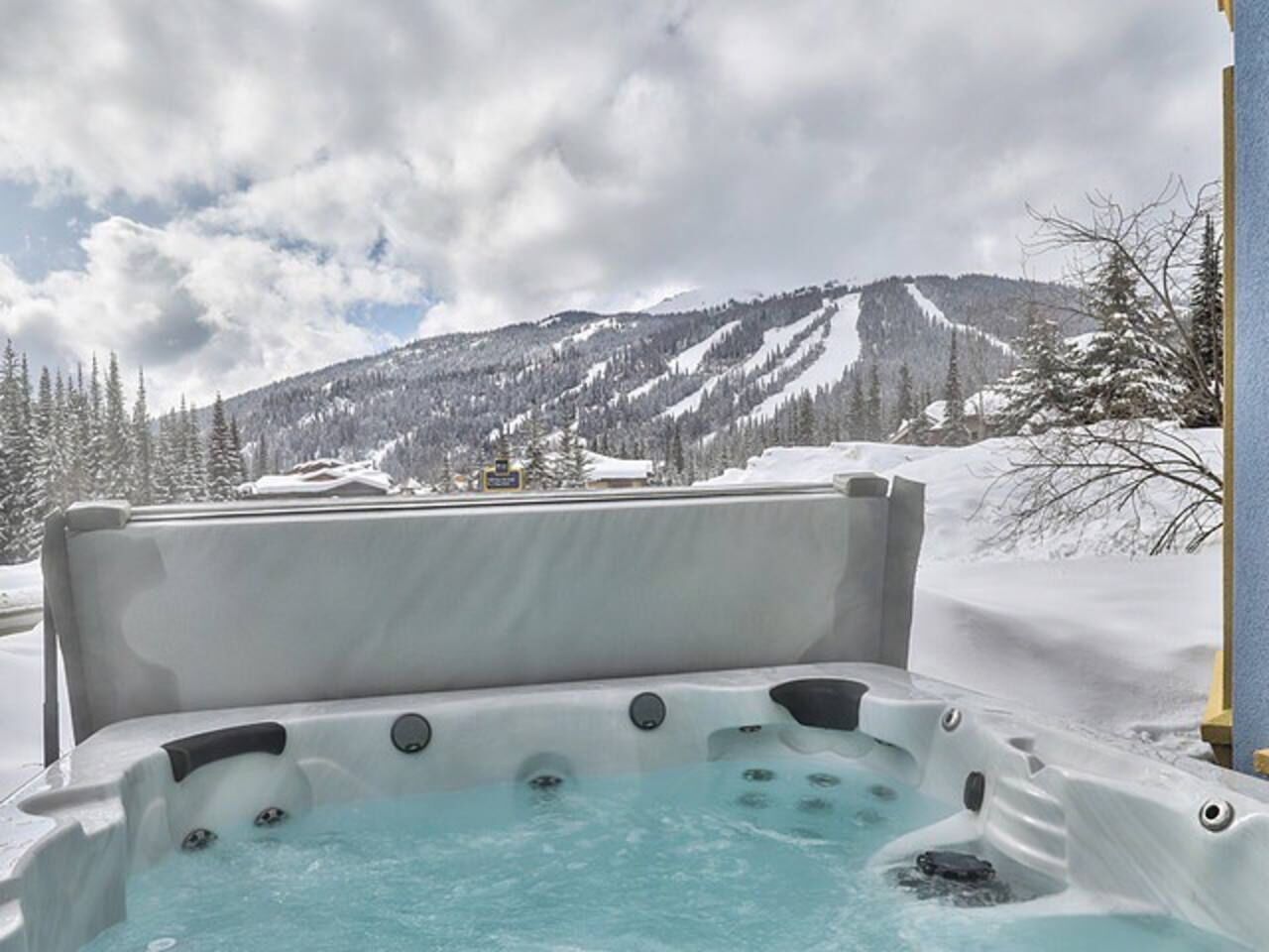 A hot tub with a mountainous backdrop.