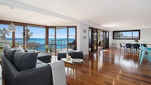 Relax in this stylish living area with a balcony offering ocean views.