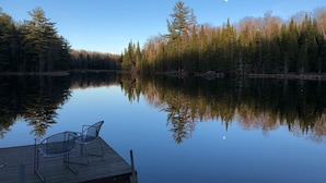 A calm lake with a wooden dock and two chairs. - Adirondack Cottage - Four Season, Pet-Friendly, Cozy & Beautiful. Read  reviews! (Lowville)