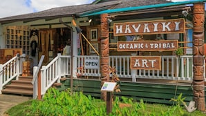 A wooden building with a sign reading "Havaiiki Oceanic & Tribal Art" and an "OPEN" sign. - Princeville Condo with AC, Pool, Garage, Beach Gear 27B (Princeville)