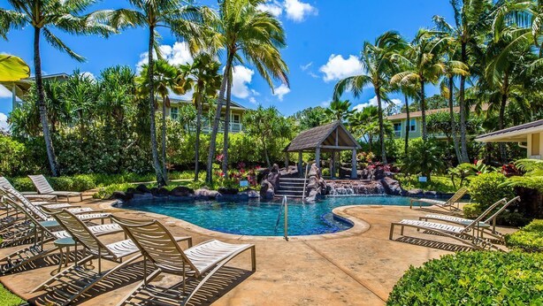 A resort pool area with lounge chairs, palm trees, and a gazebo. - Princeville Condo with AC, Pool, Garage, Beach Gear 27B (Princeville)