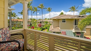 A balcony with a view of a residential area, including houses and palm trees. - Princeville Condo with AC, Pool, Garage, Beach Gear 27B (Princeville)