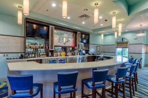 Enjoy a drink at the bar, where a variety of bottles and glasses are on offer.