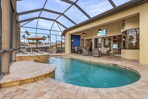 A pool area with a glass ceiling, lounge chairs, and a hot tub. - Majestic by the Yacht Club: Sailboat Access, Kayaks, Near Beach (Cape Coral)