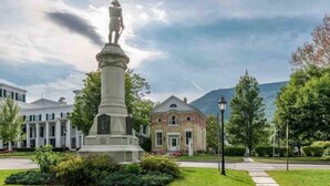 A statue in a grassy area with a building in the background. - This cottage is a 1 bedroom(s), 1.5 bathrooms, located in Manchester, VT. (Manchester)