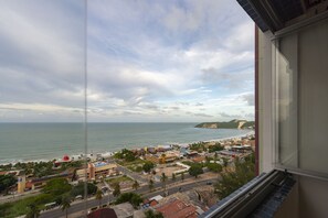 A coastal cityscape with buildings, roads, and a beach. - 2-bedroom apartment with views of Morro do Careca, 250m from the sea, garage, Wi-Fi. (Natal)