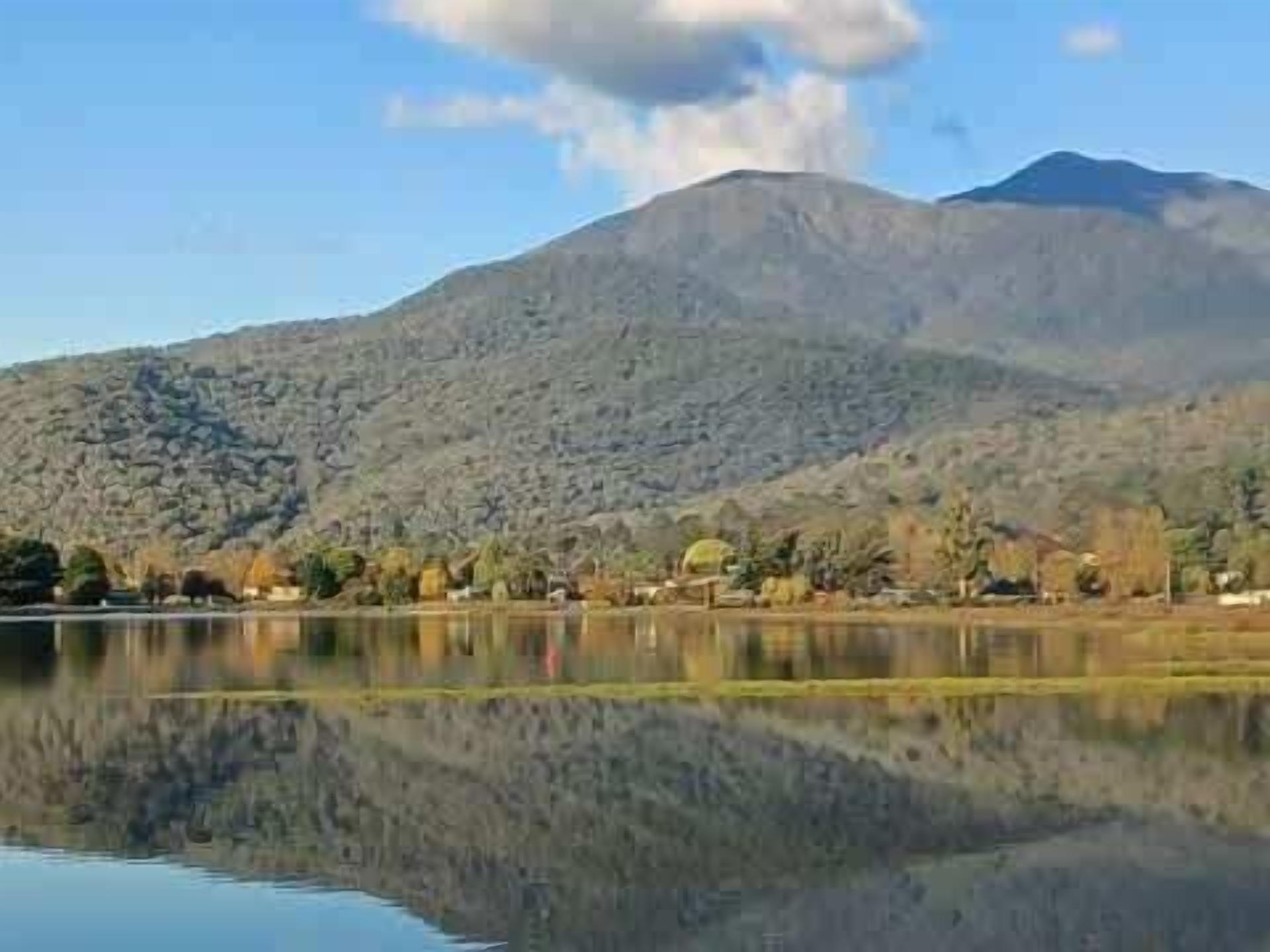 A mountain landscape with a lake reflecting the scenery.