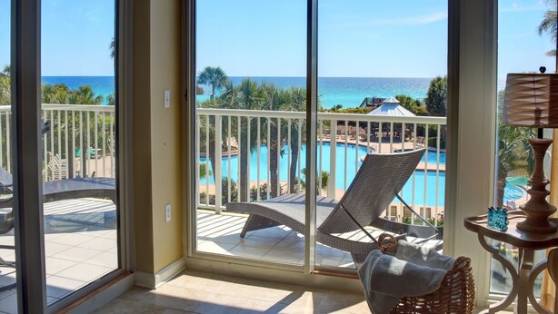 A balcony with a view of a pool and the ocean. - Gulf Front**Free Beach Service & Wi-Fi**  (Miramar Beach)
