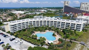 A large hotel with a curved pool and multiple balconies. - Gulf Front**Free Beach Service & Wi-Fi**  (Miramar Beach)