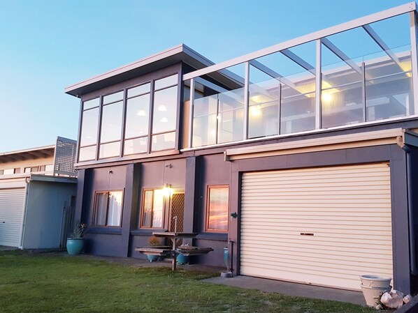 A modern two-story house with large windows, a garage, and outdoor seating. - Oceanviews-Walk to Goolwa Beach-Linen-Pet Friendly! (Goolwa Beach)