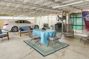 Relax in this patio area with a round table and comfortable seating.