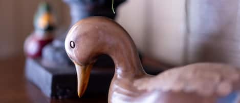 A wooden swan sculpture on a table.
