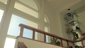 A staircase with wooden railings and a chandelier. - SOUND FRONT / Kite-in/out Direct Beachfront Access Sunsets Best Kiteboard Spot (Rodanthe)