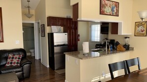 A modern kitchen with a built-in island, stainless steel appliances, and wooden cabinets.