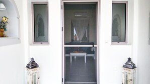 A room with a sliding glass door, a small table, and two decorative lanterns.