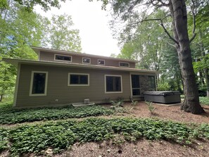 A two-story house with a large window on the first floor and a smaller window on the second floor. - Modern luxury high end retreat close to downtown Saugatuck.  (Saugatuck)