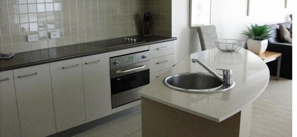 Enjoy meals in this kitchen with a central island, oven, and dining area.