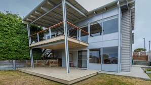 A modern two-story house with a wooden deck, large windows, and a metal roof structure. - Awesome 180° View 5*s
Central Location AVAILABLE NOV 15!










 (Albany)
