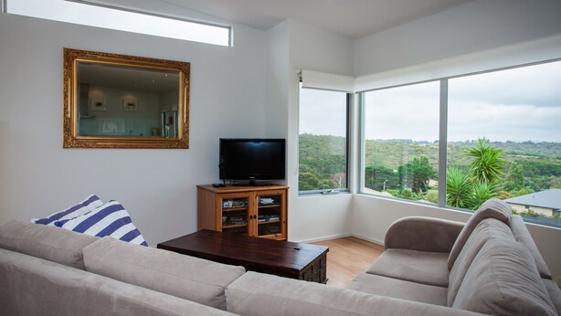 A modern living room with a large window, a flat-screen TV, and a sofa. - Awesome 180° View 5*s
Central Location AVAILABLE NOV 15!










 (Albany)