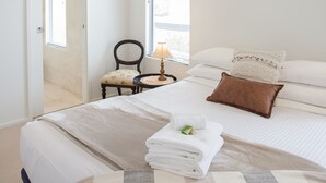 A bedroom with a bed, a chair, a lamp, and a window. - Awesome 180° View 5*s
Central Location AVAILABLE NOV 15!










 (Albany)