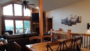 A dining area with wooden furniture, a fireplace, and artwork on the wall. -  RIDGEVIEW RETREAT/ Huge views! Hot tub, fireplaces, A/C,  and location! (Estes Park)