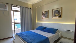 A bedroom with a bed, a ceiling fan, a window with curtains, and two wall-mounted pictures. - Fully furnished apartment with 3 bedrooms and 2 parking spaces. (Prainha)