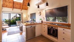 A modern kitchen with a dishwasher, oven, and a large window. - 4 Wheel Drive included. 5-minute walk from Ferry to car.
Hot on arrival Spa Pool (Onetangi)