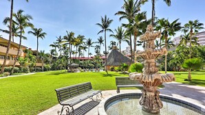 A well-maintained outdoor area with a fountain, benches, and palm trees. - Marina Sol Los Cabos Haven - Walk to Medano Beach! (Cabo San Lucas)