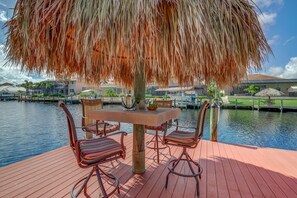 Enjoy a peaceful meal by the water's edge in this serene outdoor dining area.