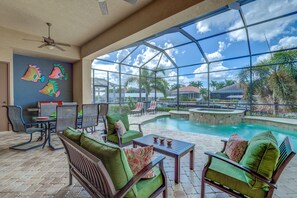 Relax in a spacious area with a clear view of the outdoor pool and surrounding landscape.